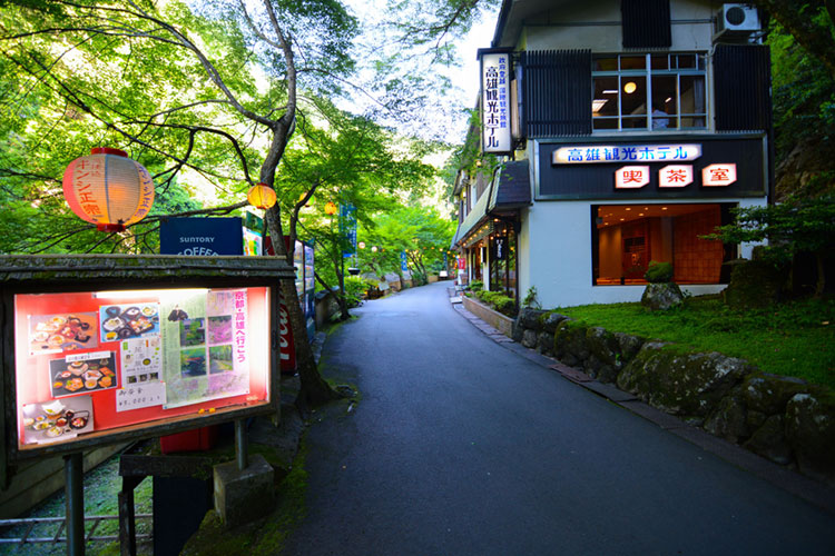 Thoroughfare along the river in Takao bordered by hotels and restaurants.